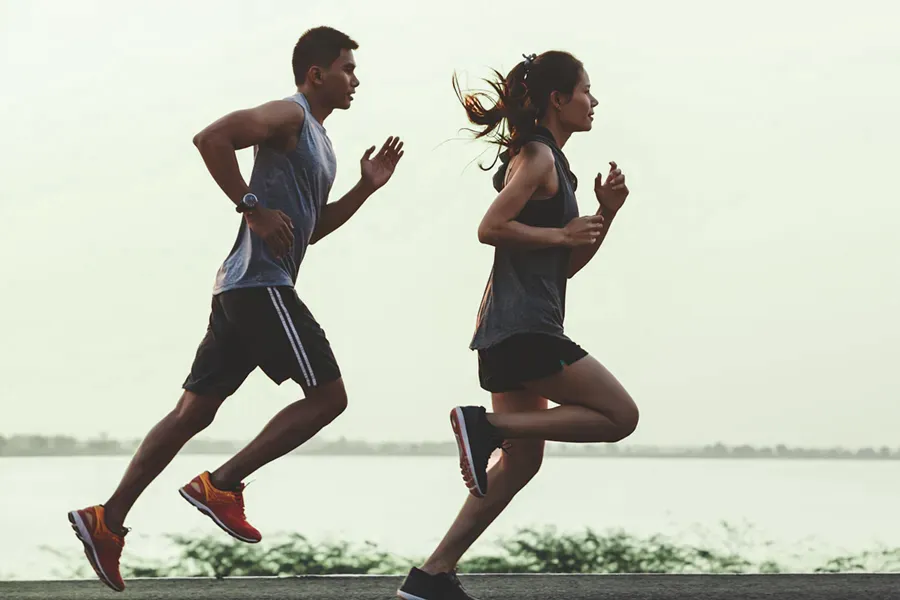 GLP-1-Weight-Loss-Injections-Clinic Man and woman running near a waterfront, reflecting the physical transformation possible with GLP-1 weight loss injections offered by AZENA Health & Longevity in Gainesville.