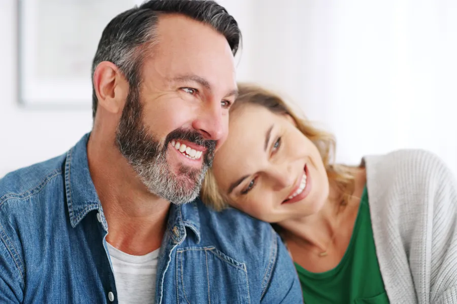 Health-and-Wellness-Services-Clinic-3 A middle-aged white couple in a bright white room smile and lay their heads on each other. Schedule concierge health and wellness services from AZENA Health & Longevity in Gainesville.