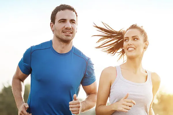 Weight-Loss-Resistance-Doctor A couple happily jogging in the sunlight after receiving effective weight loss resistance care from AZENA Health & Longevity in Gainesville.